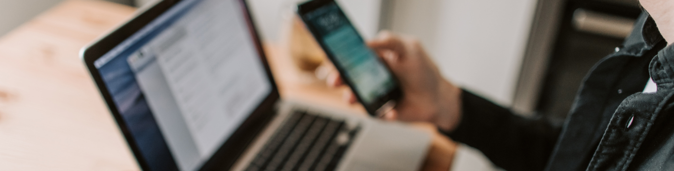 A person with laptop and mobile phone open