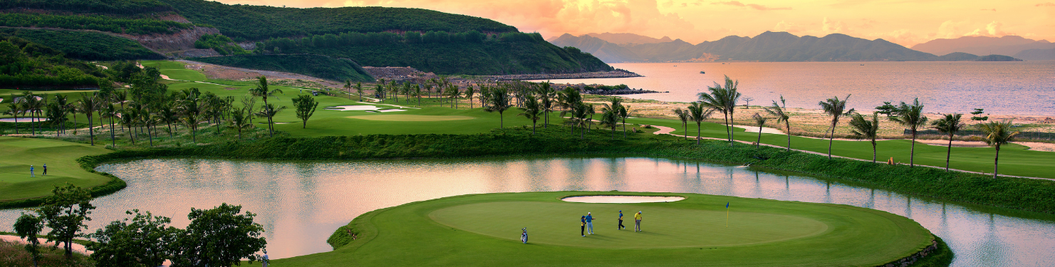 a panoramic view of a golf club overlooking the water