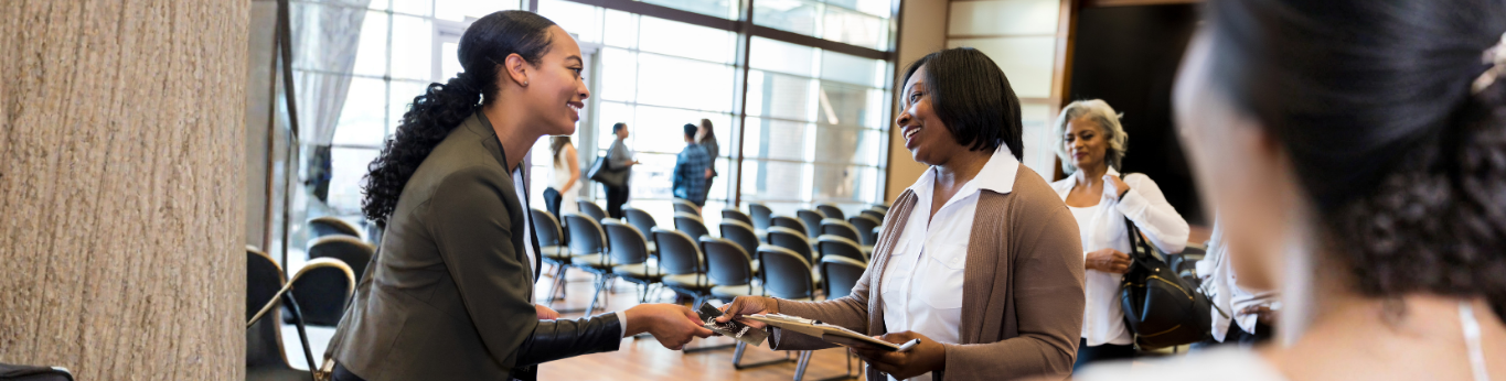 2 women at an event registration desk