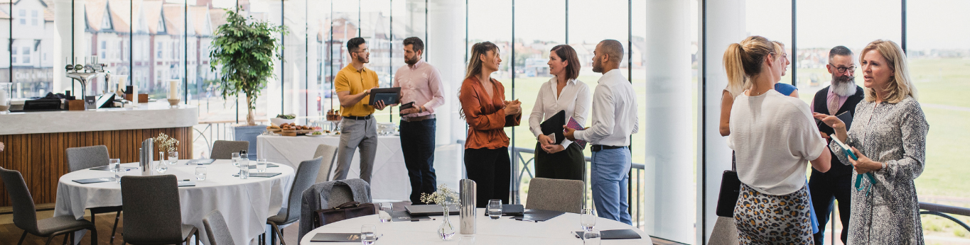 an event with attendees talking to one another an event with attendees talking to one another