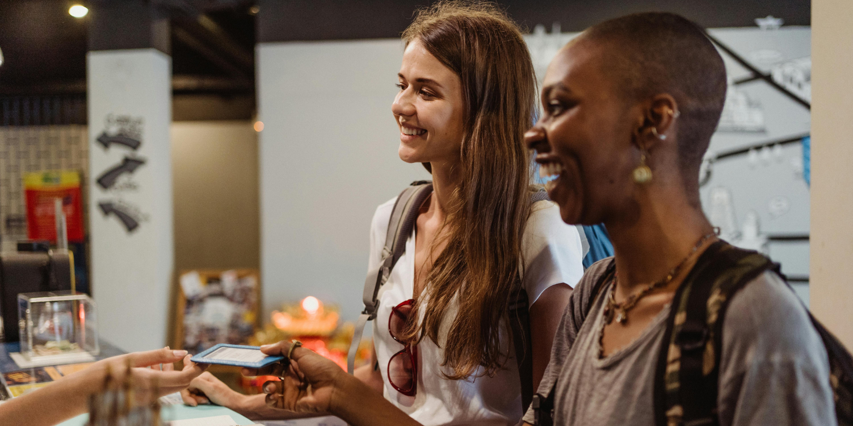 Two women speaking to venue owner